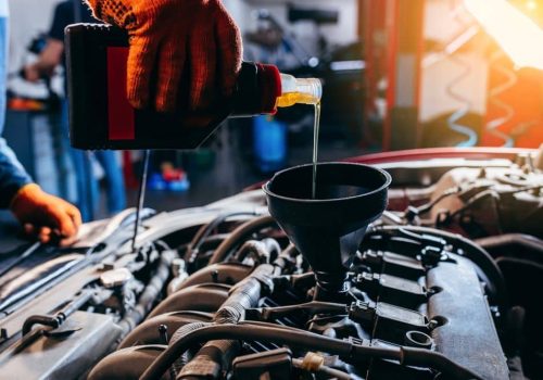 Close,Up,Hand,Of,Auto,Mechanic,Technician,Replacing,And,Pouring